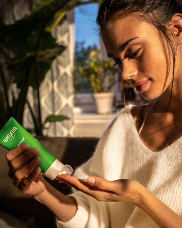 Woman applying Weleda skin food
