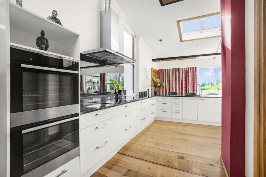 Close-up of dark granite bench and sleek integrated appliances